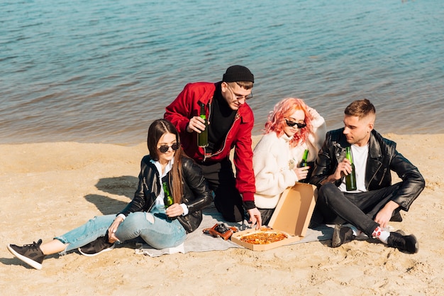 Groep vrienden op picknick bij kust
