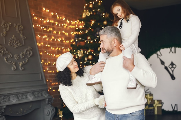 Gratis foto grootouders met hun kleindochter. kerst vieren in een gezellig huis.