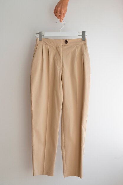 Hand vasthoudend lichtbruine beige broek