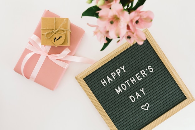 Happy Mothers Day inscriptie met bloemen en cadeau