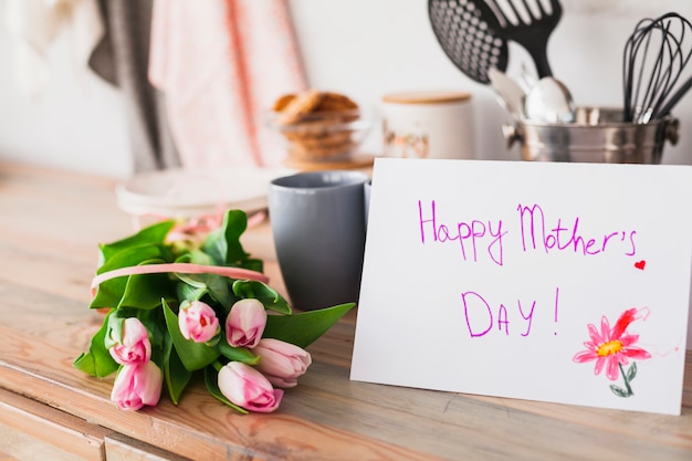 Happy Mothers Day inscriptie met tulpen op tafel