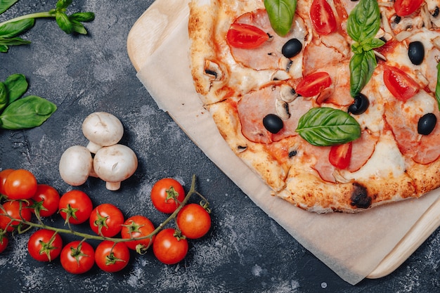 Gratis foto heerlijke napolitaanse pizza aan boord met kerstomaatjes, vrije ruimte voor tekst