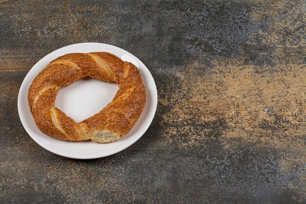 Heerlijke simit met sesamzaadjes op een witte plaat