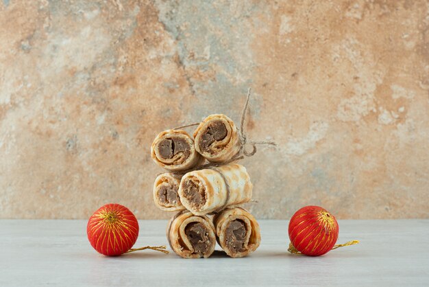 Heerlijke wafels met twee rode kerstballen op marmeren achtergrond. Hoge kwaliteit foto