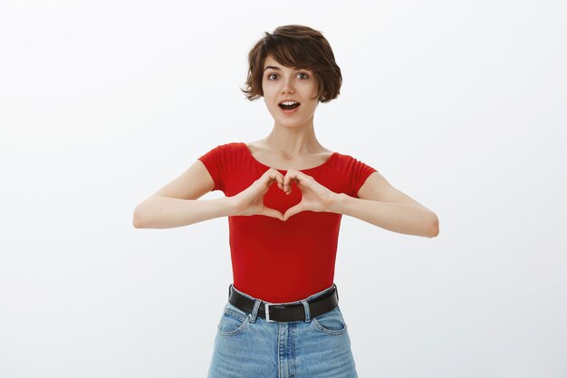 Het korte haarmeisje stellen in rode t-shirt