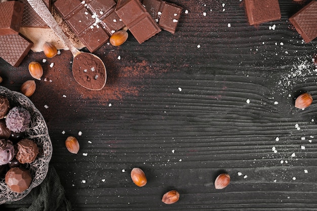 Hoge hoek chocoladerepen en lepel met cacaopoeder en exemplaarruimte