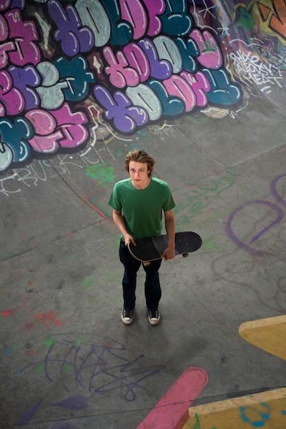Gratis foto hoge hoek tiener met skateboard