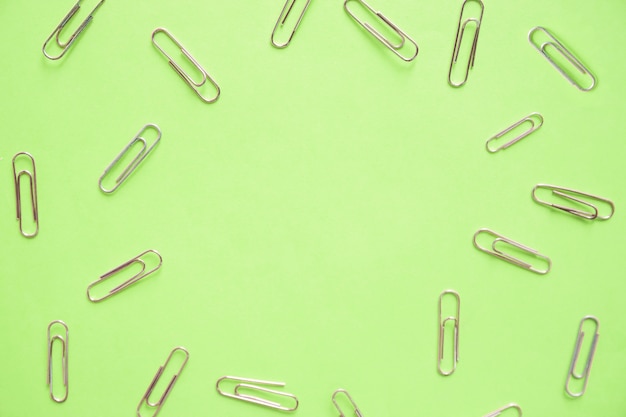 Hoge hoekmening van paperclips op groene achtergrond