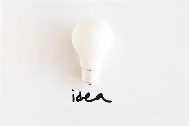 Gratis Foto hoge hoekmening van witte lamp met ideewoord