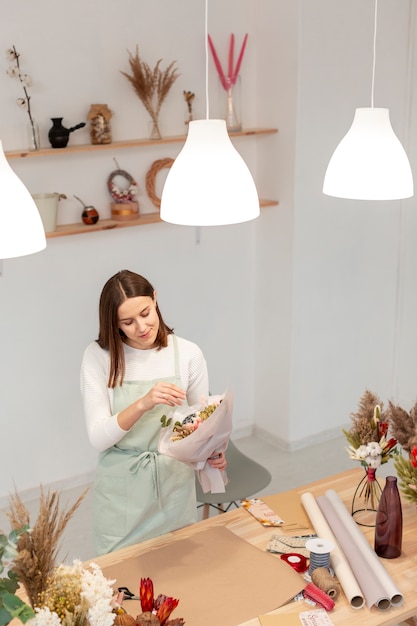 Gratis foto hoge mening zakenvrouw werken in haar eigen winkel