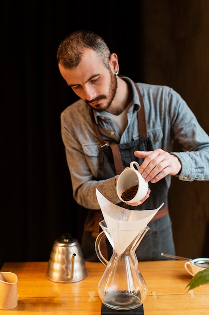 Gratis foto hoog hoekmannetje dat koffie voorbereidt