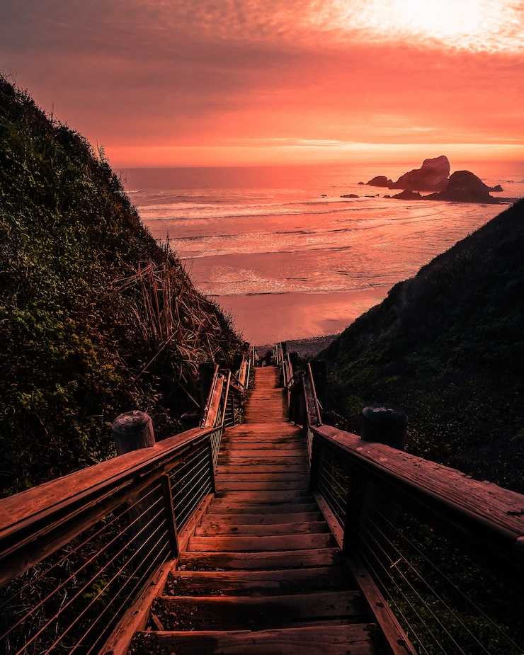 Gratis Foto houten brug naar het strand tijdens zonsondergang