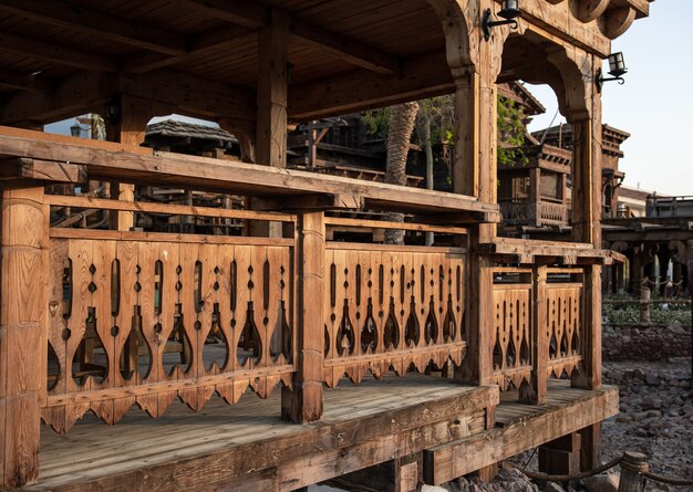 Houten uitgehouwen reling van een groot oud houten huis.