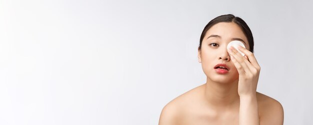 Huidverzorgingsvrouw die gezichtsmake-up verwijdert met wattenstaafje huidverzorgingsconcept Gezichtsclose-up van mooi gemengd rasmodel met perfecte huid