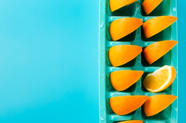 Gratis foto ijsblokjedienblad met plakken van sinaasappel