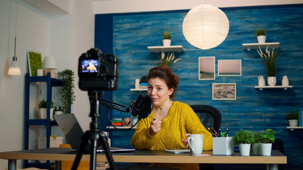 Influencer zit thuis vlogstation terwijl camera nieuwe podcast opneemt. Online show On-air productie internet uitzending host streaming live inhoud, opname van digitale sociale media communicatie