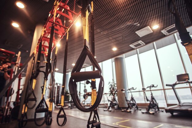 Interieur en apparatuur in de moderne sportschool, vergrote weergave van ophangriemen. Sport, fitness, gezondheid.