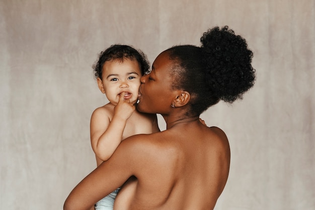 Gratis foto intiem portret van mooie moeder die haar baby vasthoudt