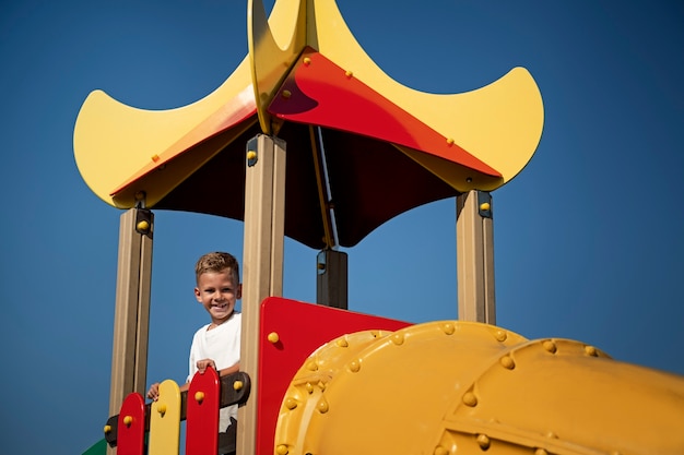 Gratis foto jong kind plezier in de buitenspeeltuin