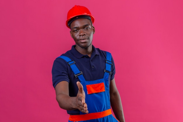 Jonge Afro-Amerikaanse bouwersmens die eenvormige bouw en veiligheidshelm draagt