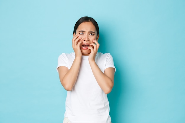 Jonge Aziatische vrouw die het toevallige T-shirt stellen draagt