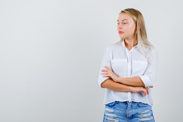 Jonge blonde vrouw in een wit overhemd