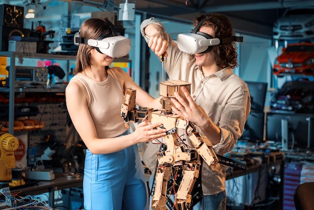 Gratis foto jonge man en vrouw in beschermende bril doen experimenten in robotica in een laboratorium robot