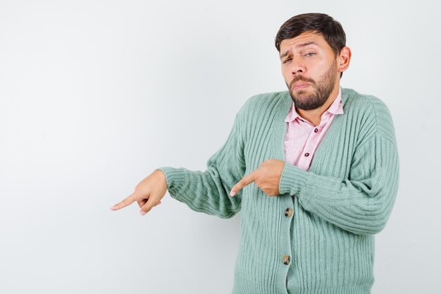 Jonge man in shirt, vest naar beneden gericht en zelfverzekerd, vooraanzicht.