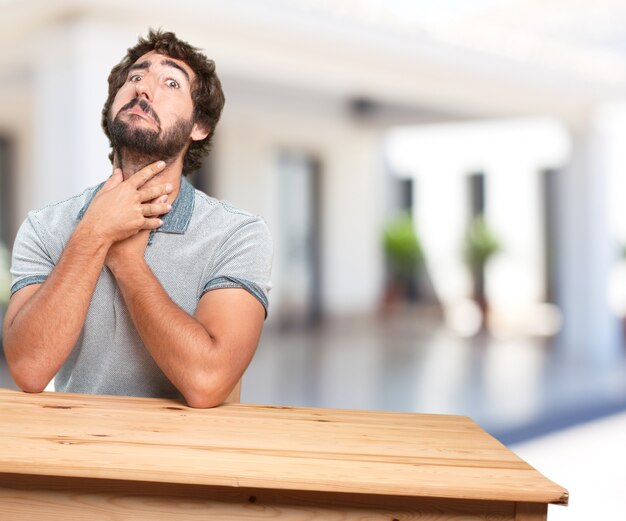 jonge man op een tafel. bezorgde uitdrukking