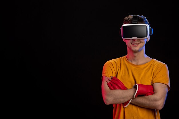 Jonge man virtual reality spelen in mma handschoenen op zwarte ondergrond