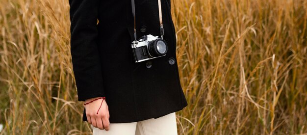 Jonge mooie vrouw in de natuur met camera close-up