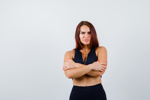 Jonge sportieve vrouw met lang haar in een zwarte top