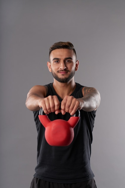 Jonge sportman training met kettlebell