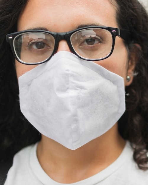 Jonge vrouw die een medisch maskerclose-up draagt