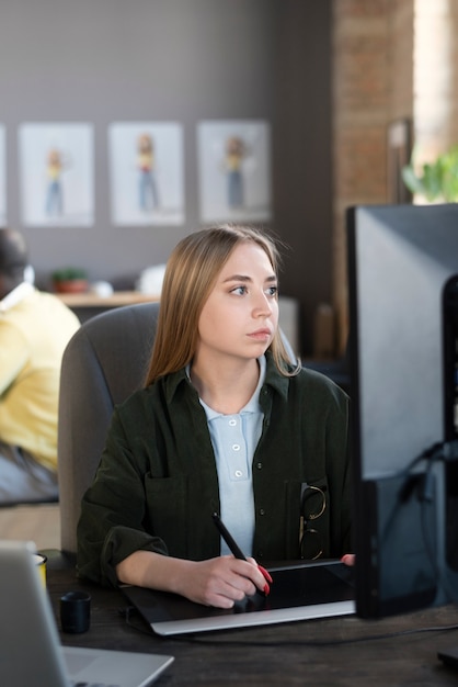 Jonge vrouw die in een animatiestudio werkt