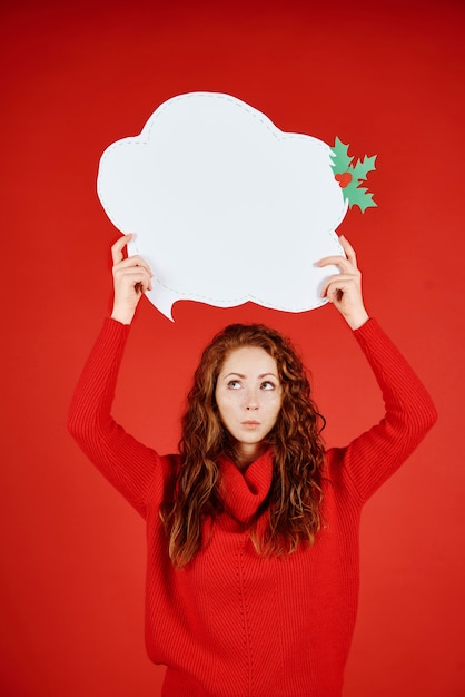 Jonge vrouw die met tekstballon omhoog kijkt