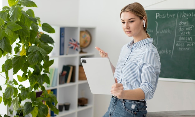 Gratis foto jonge vrouw die studenten in engelse klas online onderwijst