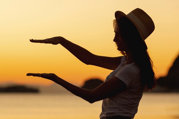 Jonge vrouw en zonsondergang op achtergrond