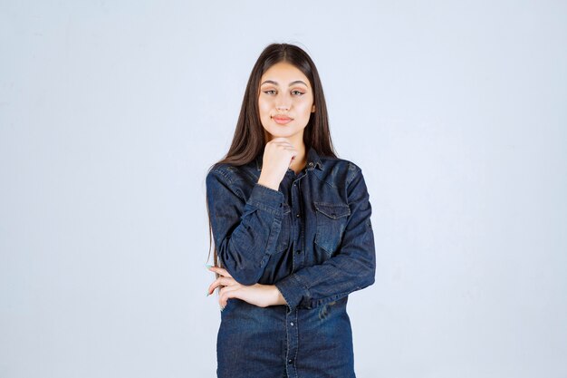 Jonge vrouw in denim overhemd neutrale en verleidelijke poses geven zonder reacties