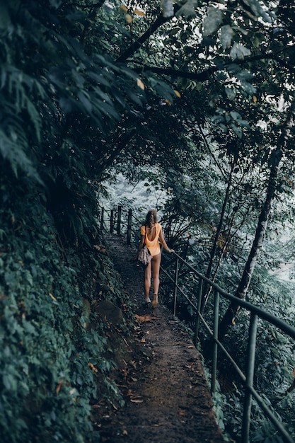 jonge vrouw met een baard en een rugzak poseren in de jungle