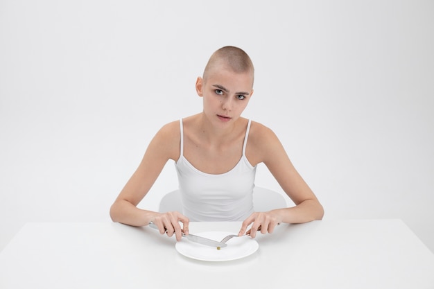 Jonge vrouw met een eetstoornis die een erwt wil eten