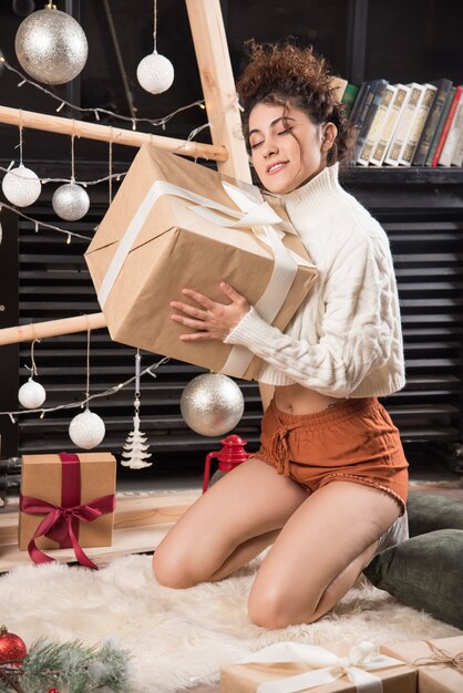 Gratis foto jonge vrouw met een grote doos kerstcadeautjes