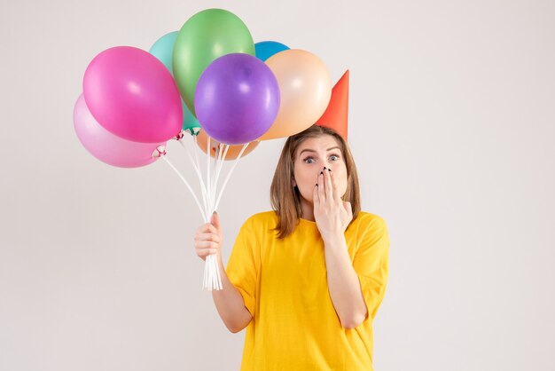 jonge vrouw met kleurrijke ballonnen op wit