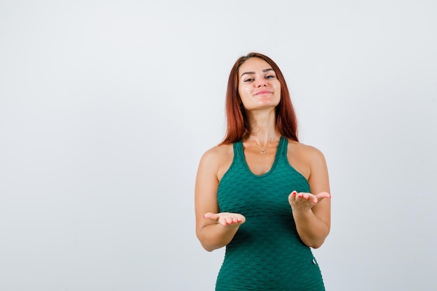 Jonge vrouw met lang haar in een groene bodycon