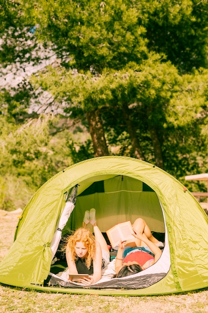 Jonge vrouwen die boeken in tent lezen