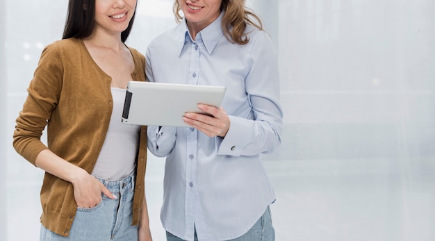 Jonge vrouwen die op een tablet doorbladeren