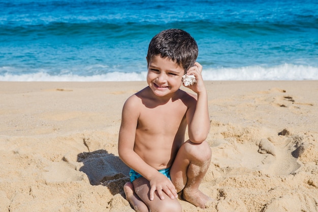 Jongen die door een shell hoort