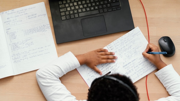 Jongen huiswerk met gebruik van laptop