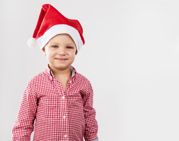 Jongen lachend met hoed van de kerstman