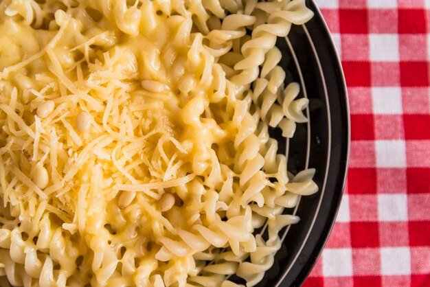 Kaas op verse pasta op plaat op tafel